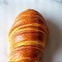 Golden buttery croissant on a marble plate